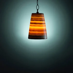 Modern onyx pendant light fixture with warm, amber glow.