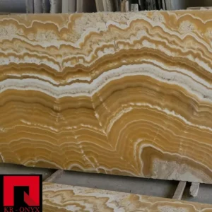 0005 Honey Onyx Slab: Natural stone slab featuring beautiful amber and white swirling patterns. Perfect for countertops or decorative projects.