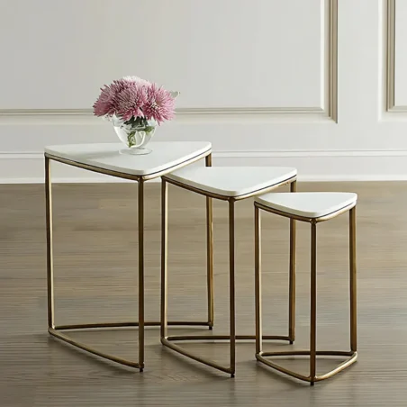 Gold metal nesting triangle tables with white marble tops.