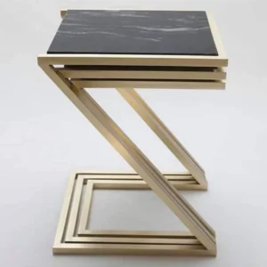 Modern gold metal side table with black marble top