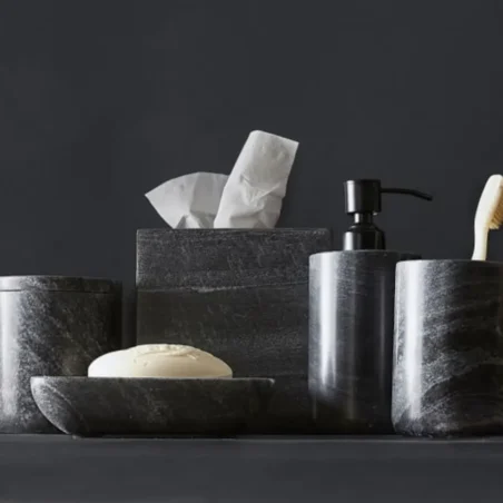 Dark gray marble bathroom accessories: tissue box, soap dish, lotion dispenser, and toothbrush holder.