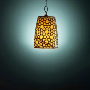 Intricate hanging lantern with geometric pattern, illuminated against a dark teal background.