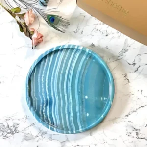 Round teal agate serving tray with white stripes.