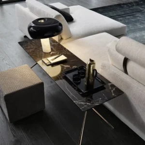 Modern marble console table with black lamp and gold tray, stylish living room decor.