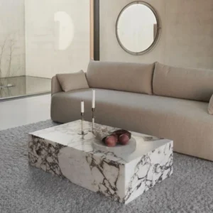 Modern marble coffee table in living room with beige sofa