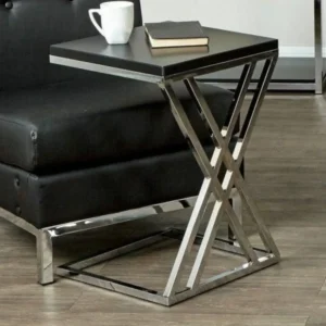Modern black side table with chrome X-frame base, next to a black chair.