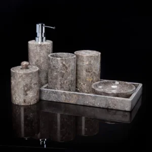 Grey marble bathroom accessories set: soap dispenser, toothbrush holder, tray, and jar.