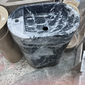 007 Modern Marble Pedestal Sink: Stylish black and white marble bathroom sink with an oval basin.