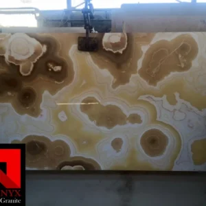 0006 Honey Onyx: Large slab of natural Honey Onyx marble featuring beautiful swirling patterns in light and dark brown with white accents. Ideal for countertops, backsplashes, or flooring.