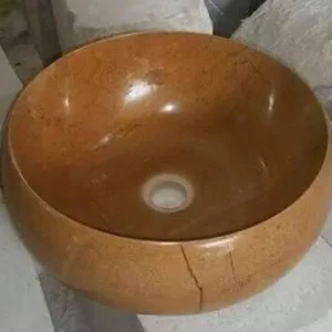023 Natural Stone Vessel Sink: A beautiful light brown marble or onyx bathroom sink with a round design and subtle veining.