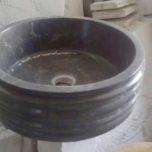 024: Elegant round marble vessel sink, dark grey/black, perfect for modern bathrooms.