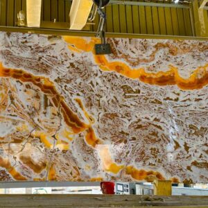 Stunning Onyx Slab: Large, polished slab featuring a dramatic swirl of white, orange, and brown natural stone. Perfect for countertops or decorative features.